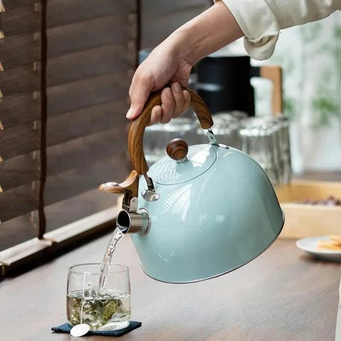 Whistling stovetop kettle with a drip-free spout & ergonomic, cool-touch handle for hot beverages.