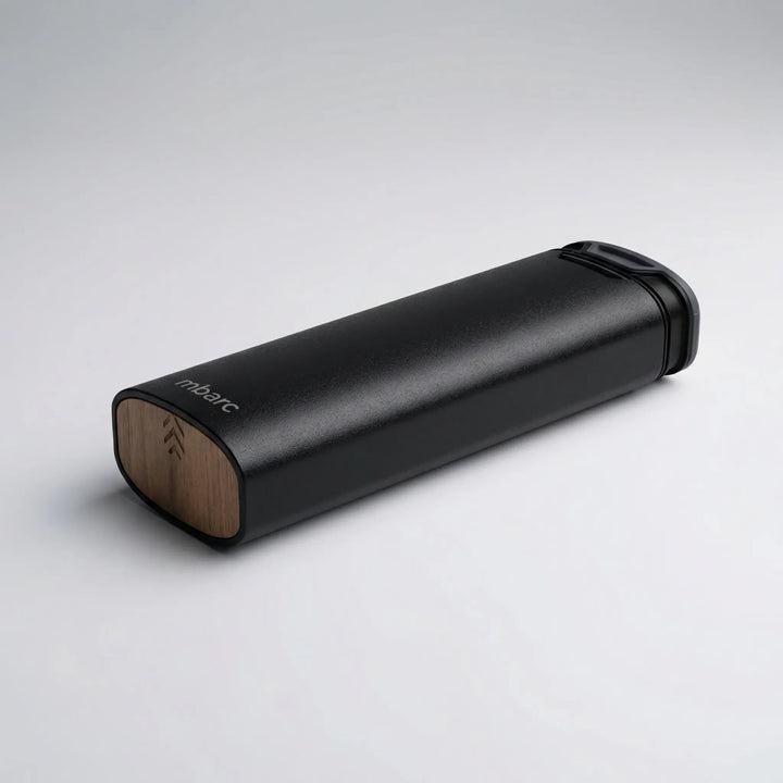 Daily medication planner: a 7-day pill box with sleek aluminum and natural wood design for health management.
