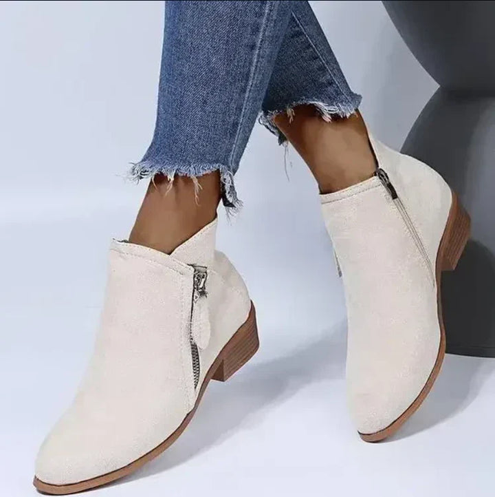 Stylish women's ankle boots with a zip heel, available in black, perfect for fashion-conscious outfits.