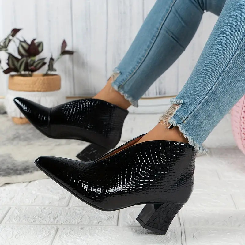 Detail of the comfortable sole and reptile texture on women's versatile winter ankle boots.