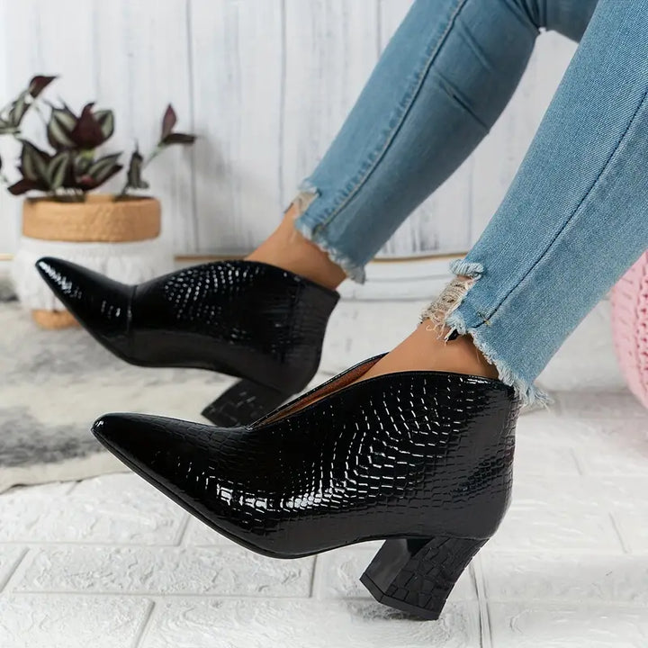 Detail of the comfortable sole and reptile texture on women's versatile winter ankle boots.
