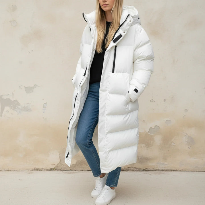 Comfortable women's hooded long puffer jacket. Stylish winter outerwear for ultimate warmth in cold weather.