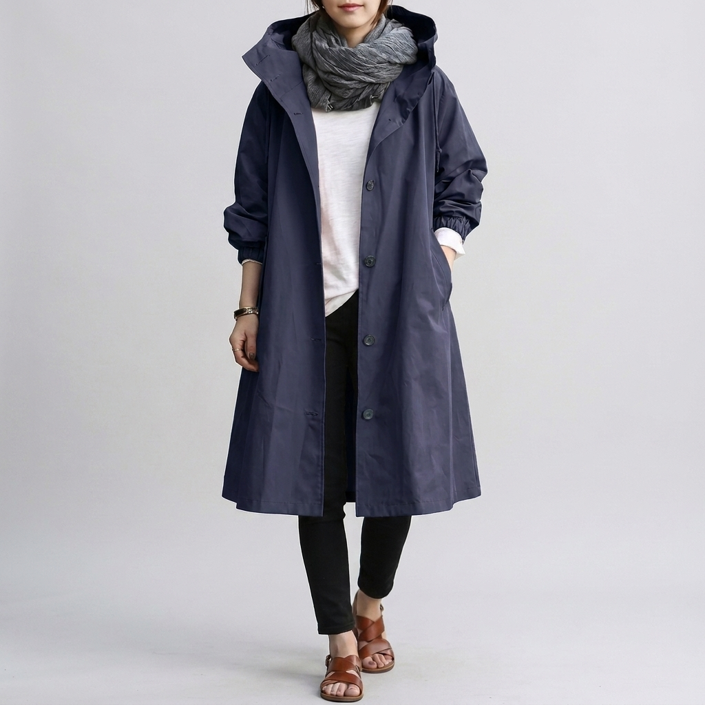 Water-resistant women's oversized hooded raincoat, long-sleeve, for ultimate wet weather protection.