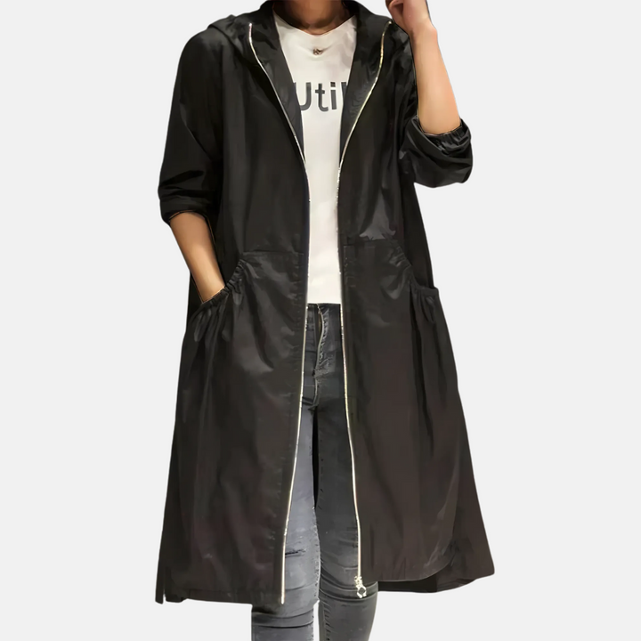 Lightweight women's knee-length rain jacket with hood, water-resistant for stylish and practical outdoor protection.