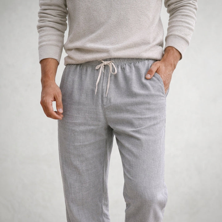 Casual unisex linen trousers with a practical drawstring waist, offering breathable comfort for summer days.