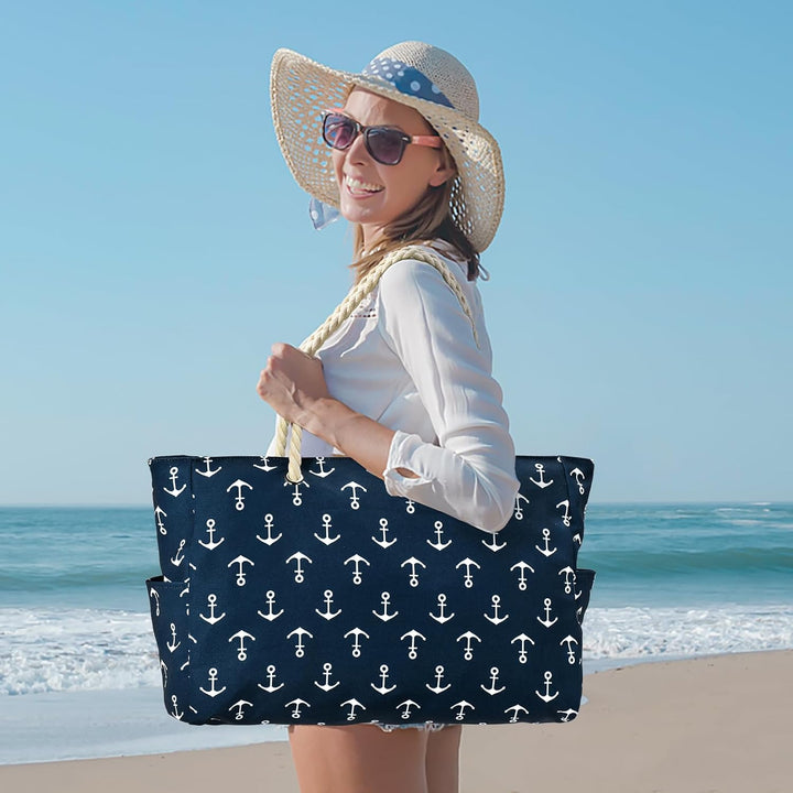 Beach scene with a large waterproof tote bag resting on sand, vibrant color.