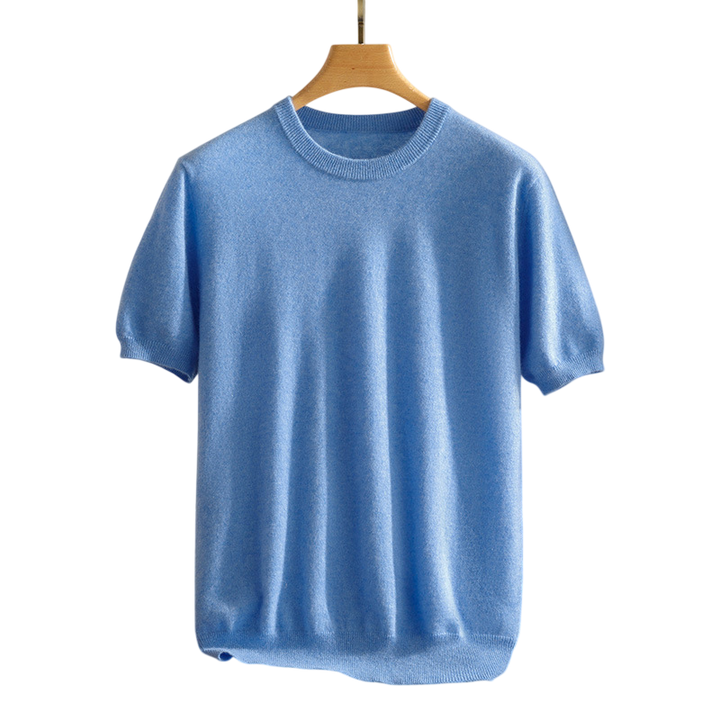 Detail of the classic crewneck on a soft, breathable unisex cashmere tee, perfect for luxurious comfort.