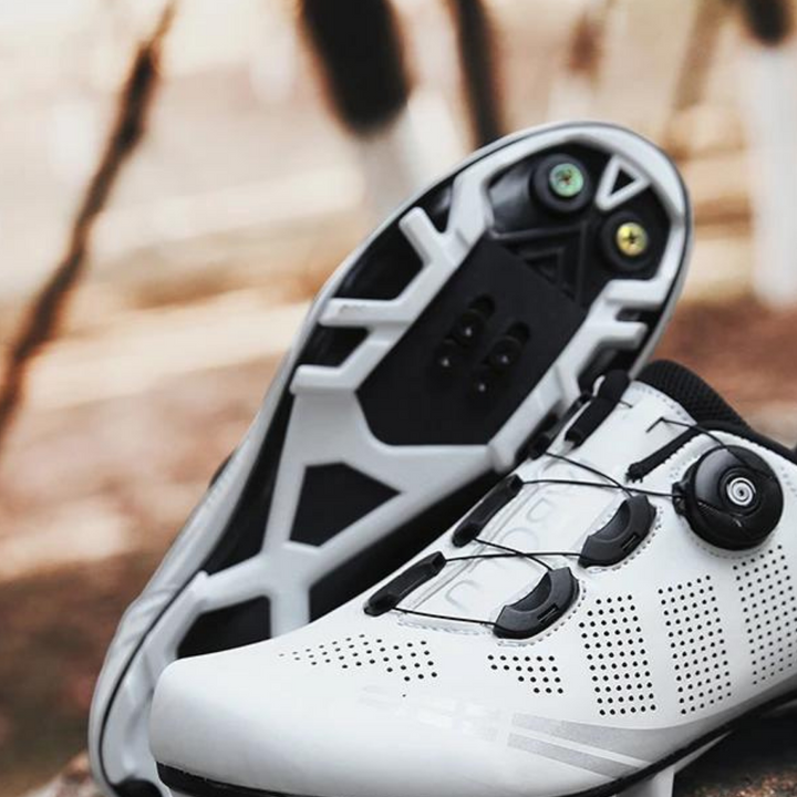 Red unisex cycling shoes with orthopedic design, built for peak performance & durability on road bike rides.