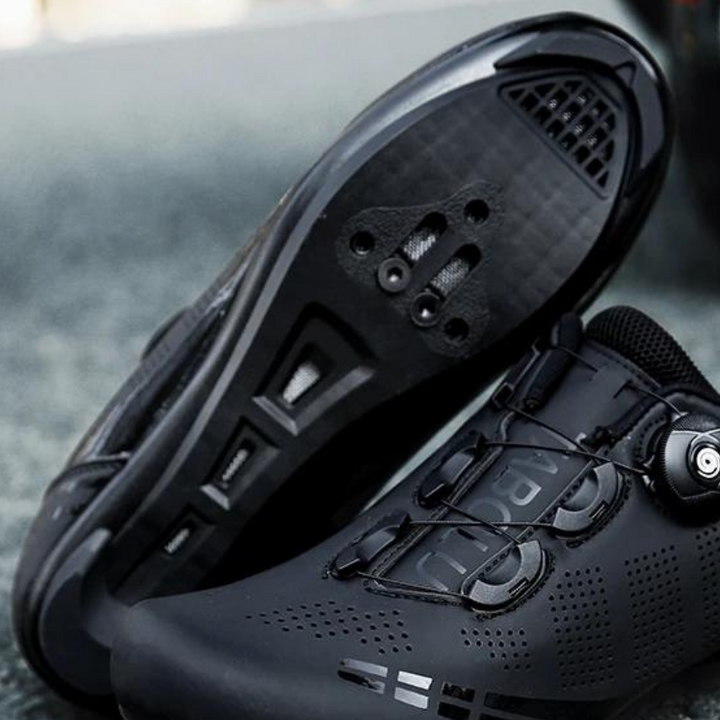 Black & white unisex orthopedic cycling shoes for road biking, offering superior comfort and foot support for activewear.