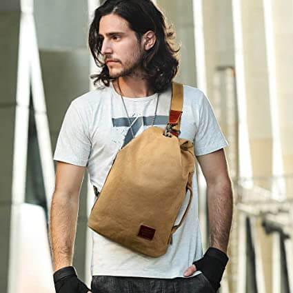 Woman wearing a unisex canvas sling bag, perfect for daily errands.