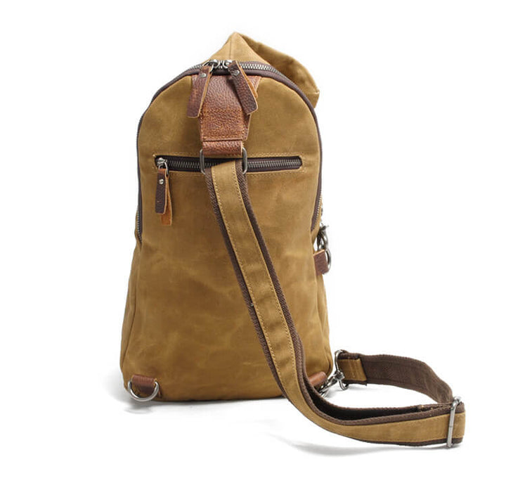 Front view of a water-resistant canvas crossbody bag with secure zipper.