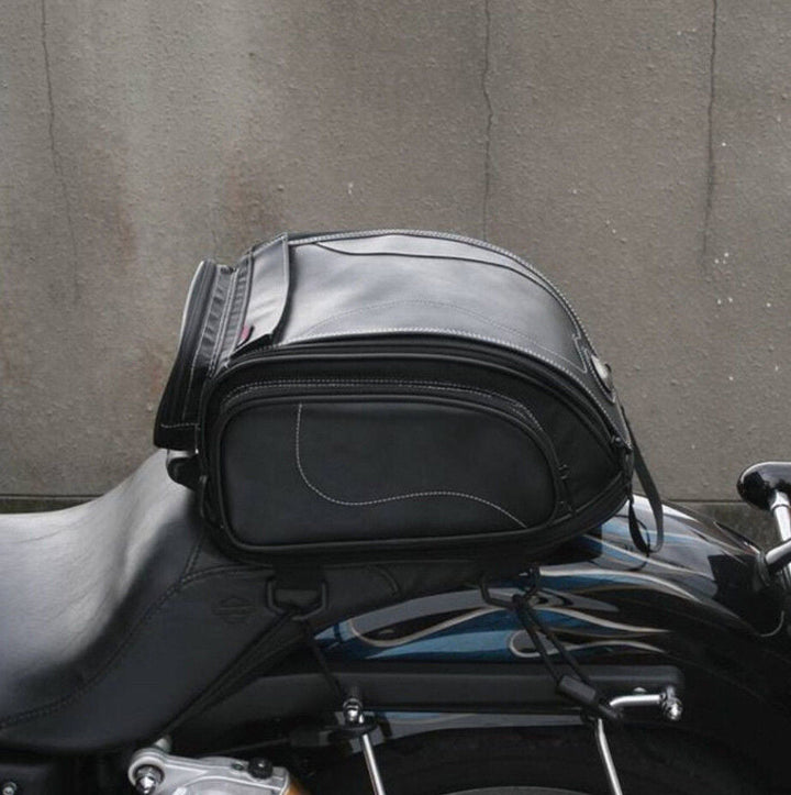 Durable water-resistant motorcycle tail bag protecting contents from rain, ideal for all-weather riding gear.