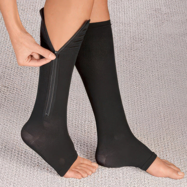 Close-up of the durable zipper on unisex compression socks, providing easy on/off & firm leg support.