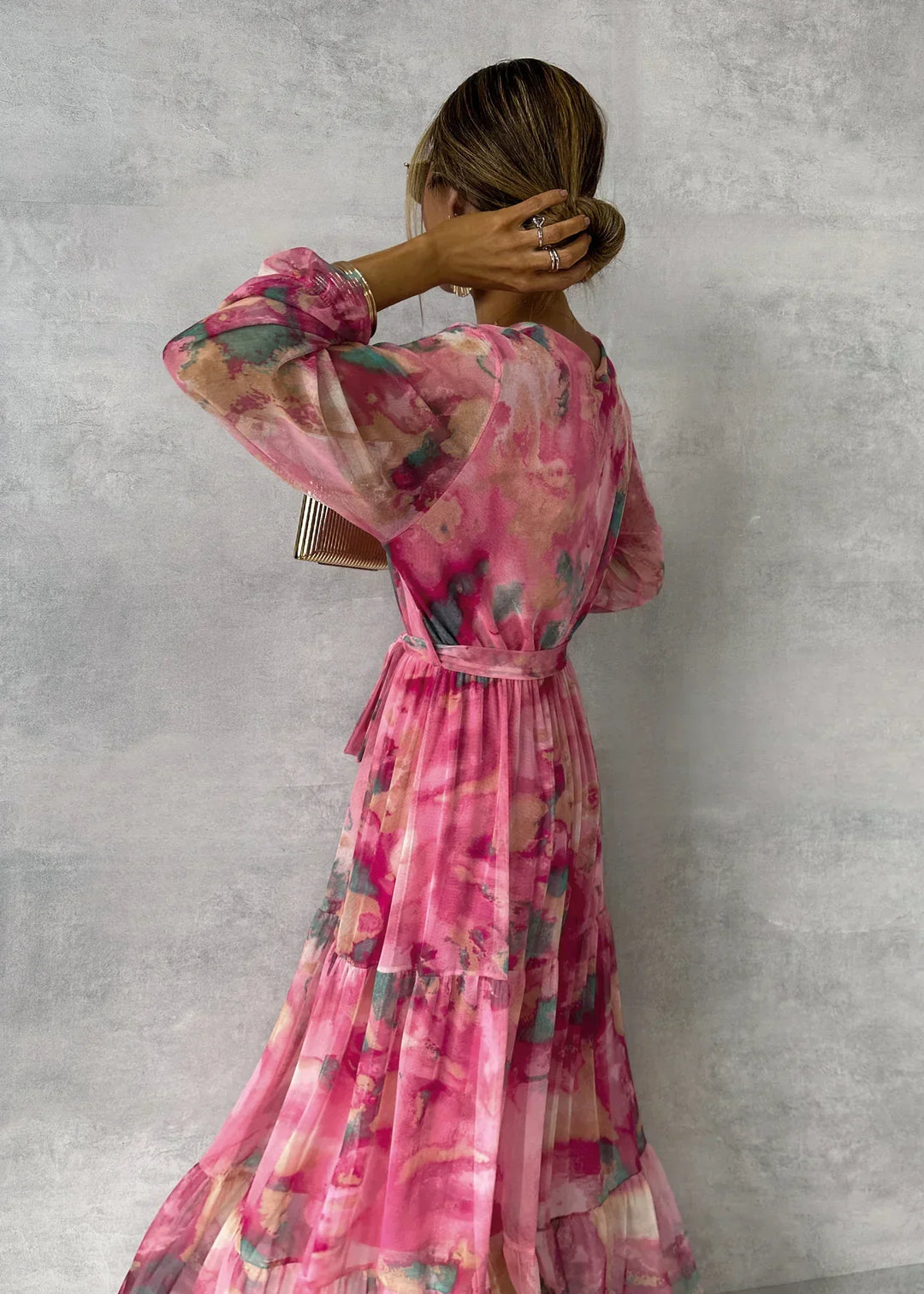 Women's elegant floral wrap maxi dress with V-neck, ruffled sleeves, and tiered skirt, ideal for weddings.