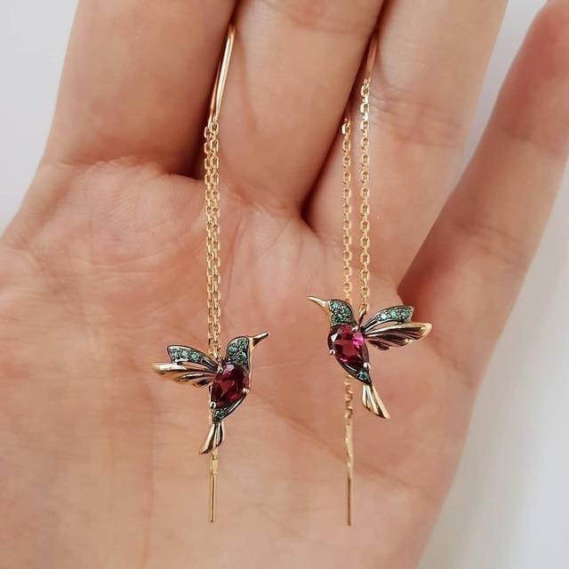 Vibrant red enamel hummingbird earrings for women, featuring sparkling zirconia. Stylish statement animal jewelry fashion accessory.