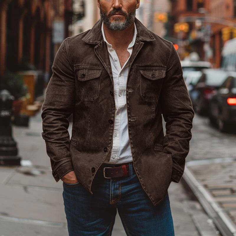 Distressed fabric texture of a durable men's multi-pocket work jacket for rugged outerwear.