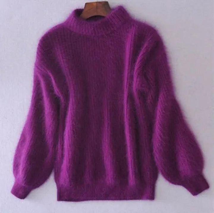 Close-up of a women's high neck knit sweater, highlighting the intricate knitwear and warm fabric.