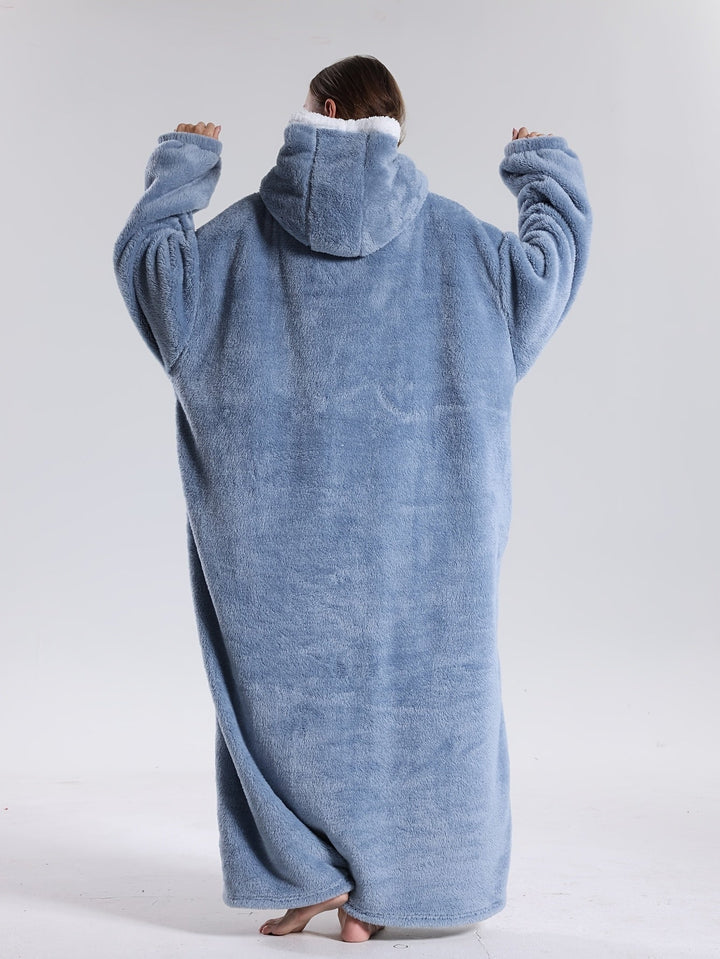Oversized unisex hoodie blanket with large front pocket, ideal for cozy lounging at home.