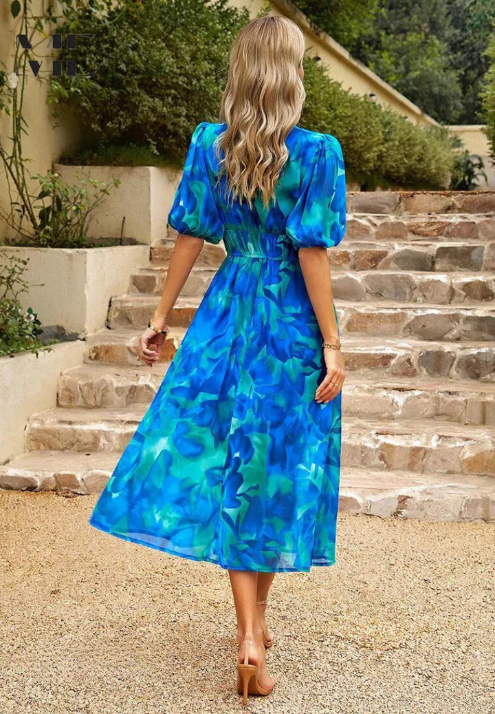 Casual yet elegant women's midi dress, showcasing a vibrant abstract print.