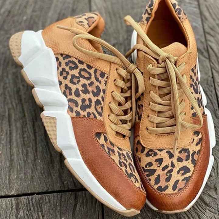 Close-up of a women's animal print lace-up sneaker, highlighting texture and unique design.