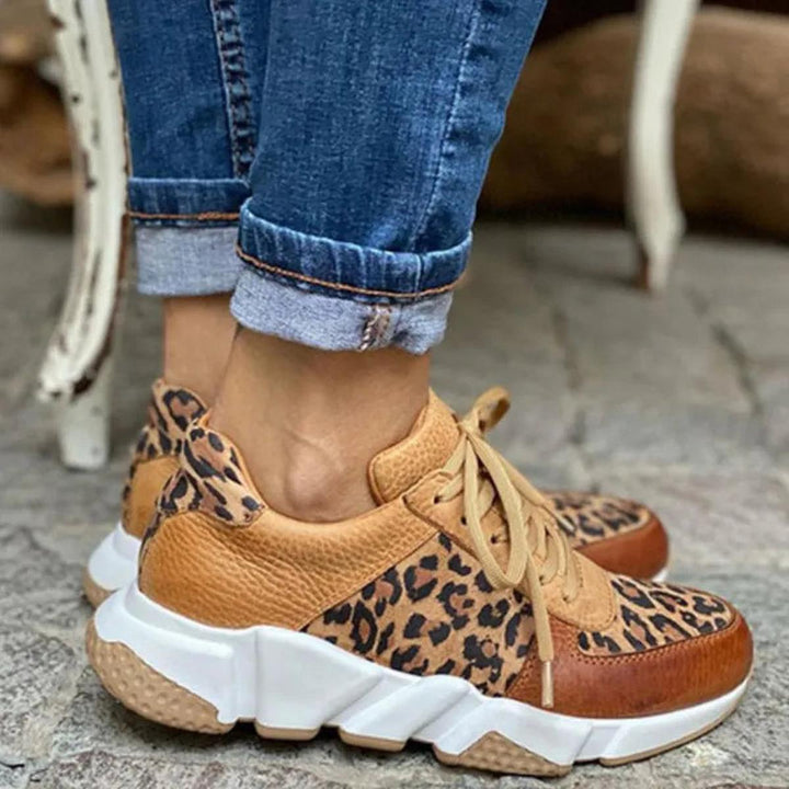 Pair of women's animal print lace-up sneakers, ideal casual footwear for walking and style.