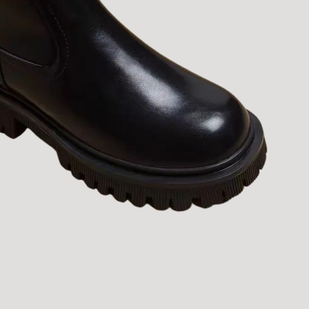 Fashionable black mid-calf boots for women, featuring a chunky platform design