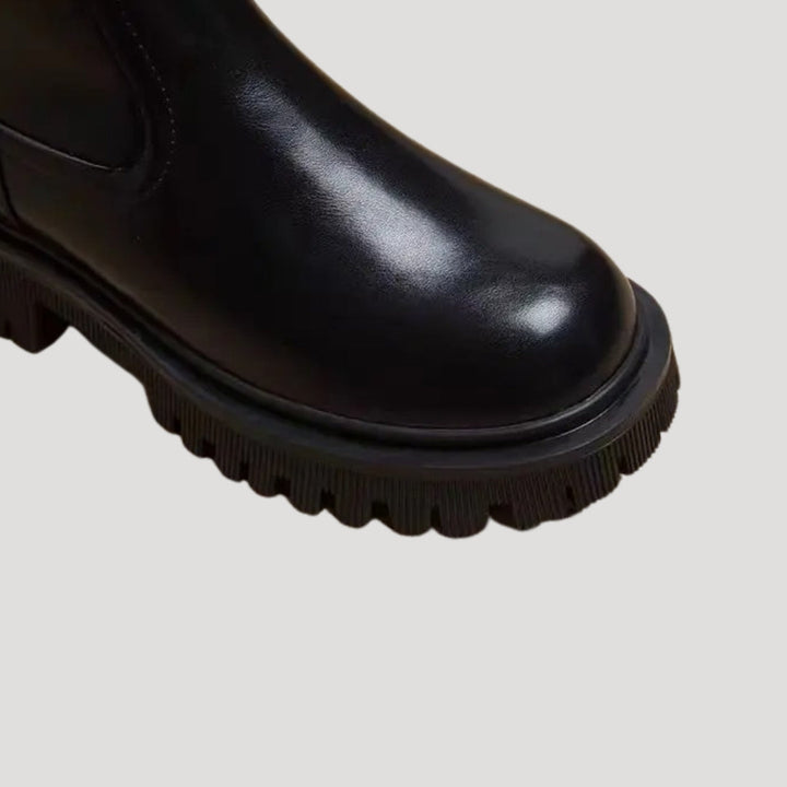 Fashionable black mid-calf boots for women, featuring a chunky platform design