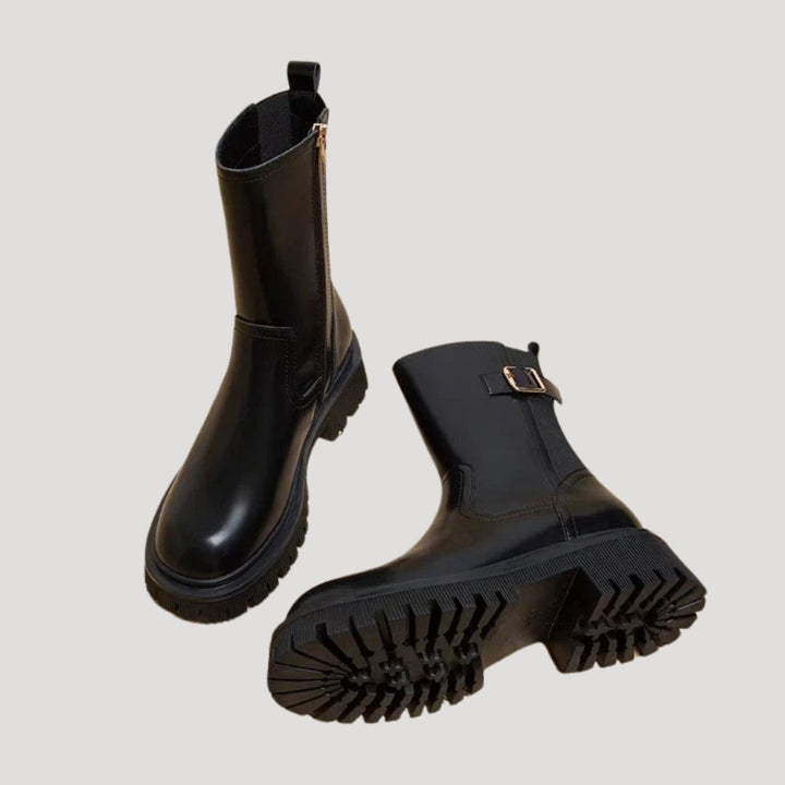 Detail of the chunky sole on women's black mid-calf spring boots, modern design