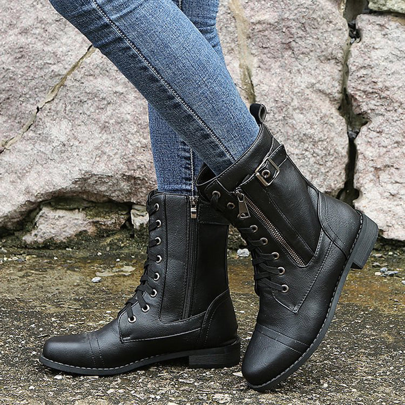 Women's combat boots with an open side zip, revealing the interior lining, ready for easy wear.