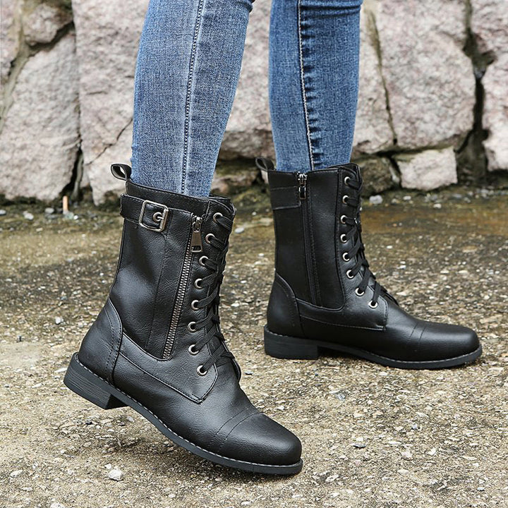 Top-down view of women's rugged combat boots, showing the lacing and side zip detail, ideal for winter.