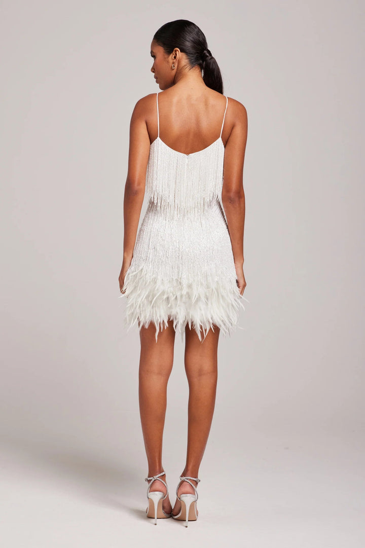 Model wearing a sophisticated women's fringe feather cocktail dress, full length shot