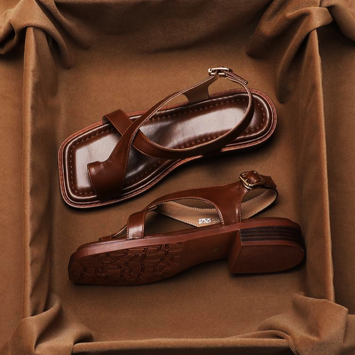 Women's black leather cross strap comfort sandals, ideal for elegant summer footwear