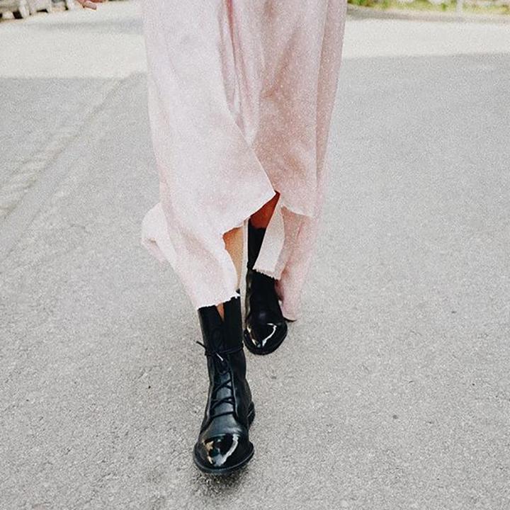 Pair of women's black leather ankle boots, lace-up style, sturdy sole for ultimate durability.