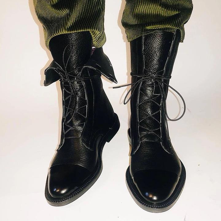 Elegant women's leather boots, lace-up detail, sturdy sole for traction and support.