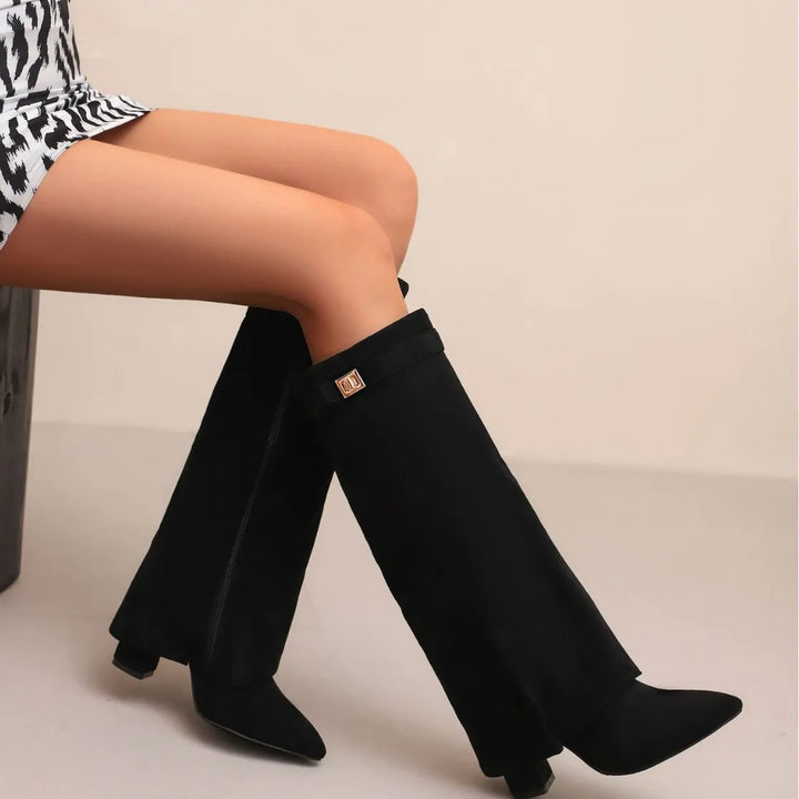 Close-up of buckle detail on women's black leather thigh-high boot