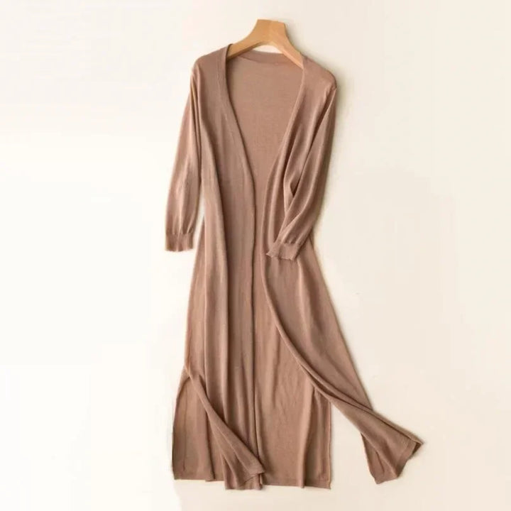 Side view of a white women's longline cardigan, showcasing its elegant relaxed fit