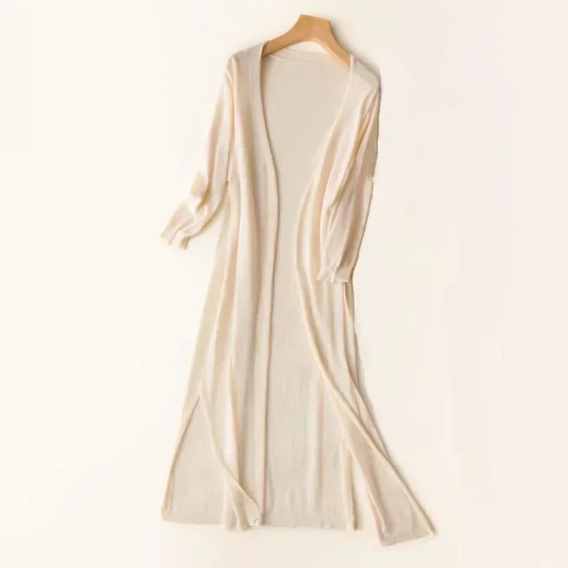 Detailed shot of the flowy hem of a women's relaxed fit longline cardigan, emphasizing its length