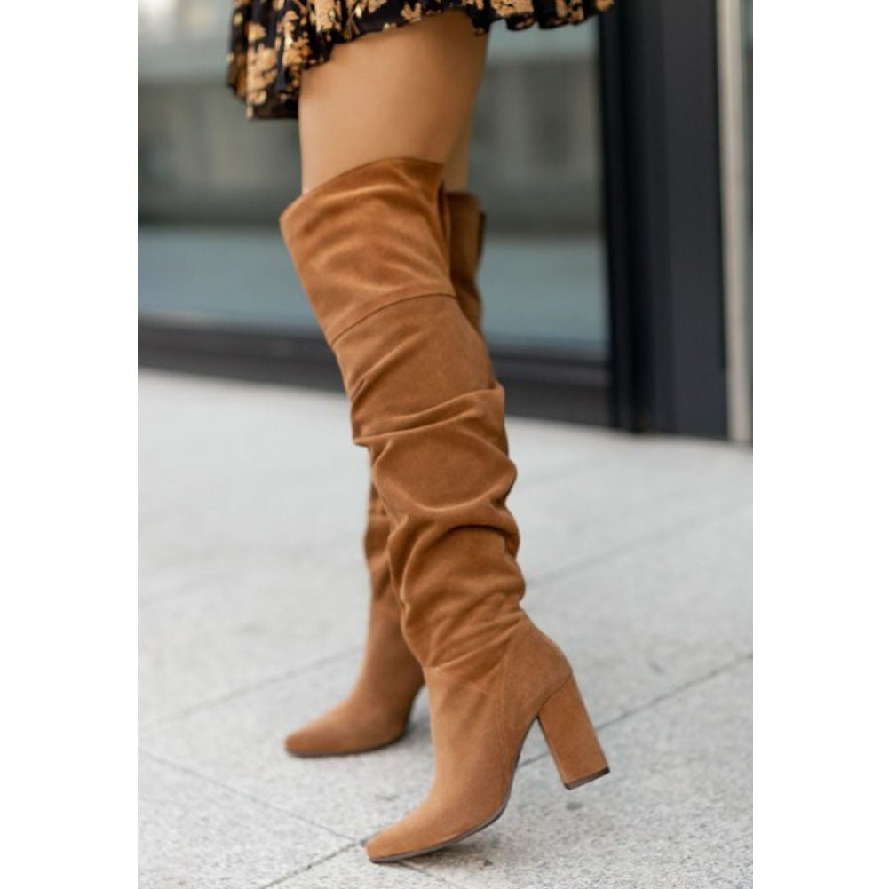 Elegant women's over-the-knee high heel boots in black, featuring a pointed toe and comfortable block heel.