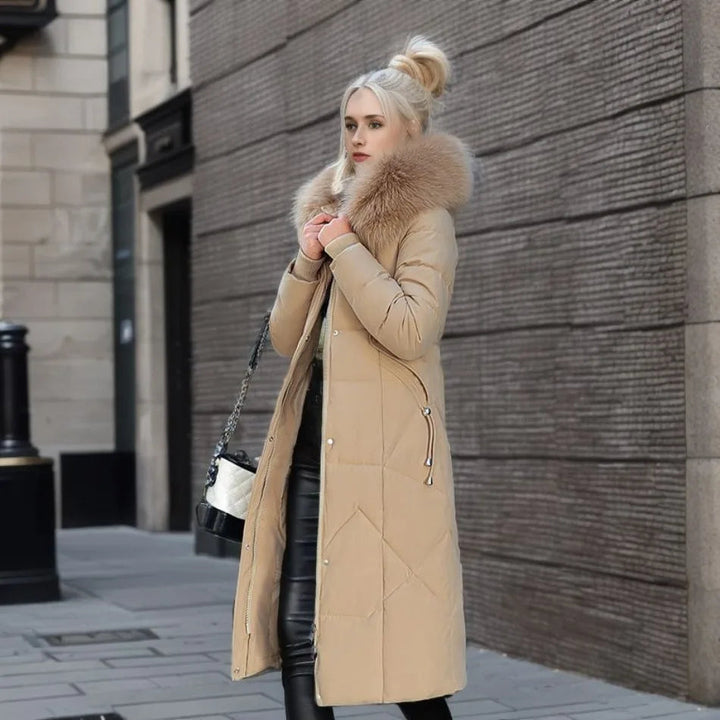 Fashion-forward women's black quilted winter coat, with a generous faux fur hood, full shot