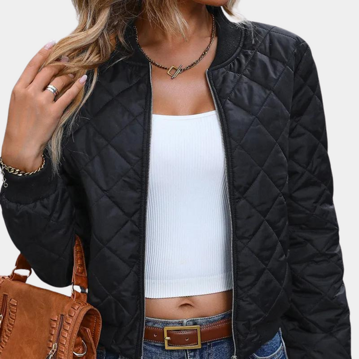 Cropped women's quilted zip-up jacket in black, offering a chic and versatile look for everyday wear.