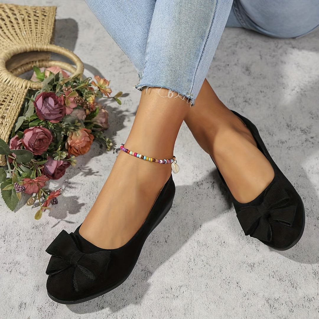 Chic women's slip-on ballet flats with a graceful bow and walkable wedge.