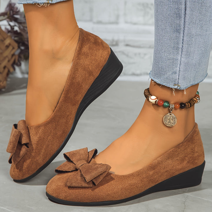 Walking comfort: women's wedge ballet flats, easy slip-on style, bow detail.
