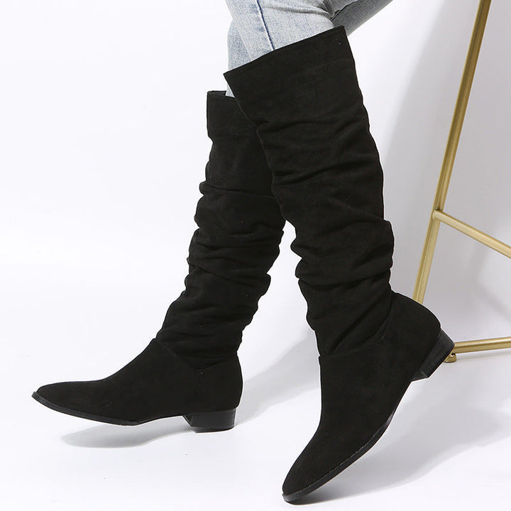 Women's black slouchy knee-high boots with a comfortable block heel, perfect for fall and winter fashion.