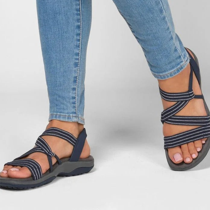 Close-up of women's beige comfort sandals with adjustable multi-strap design for outdoor