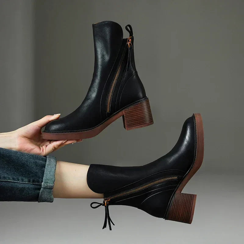 Women's black zip-up ankle boots with a comfortably stacked block heel, perfect for autumn fashion.