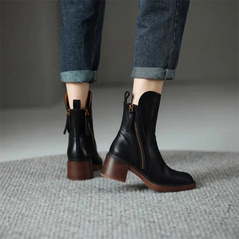 Fashionable women's zip-up boots featuring a sturdy block heel, making them versatile ankle footwear.