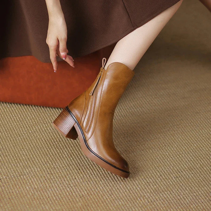 Close-up of a women's block heel boot, highlighting the quality material and practical zip-up design.