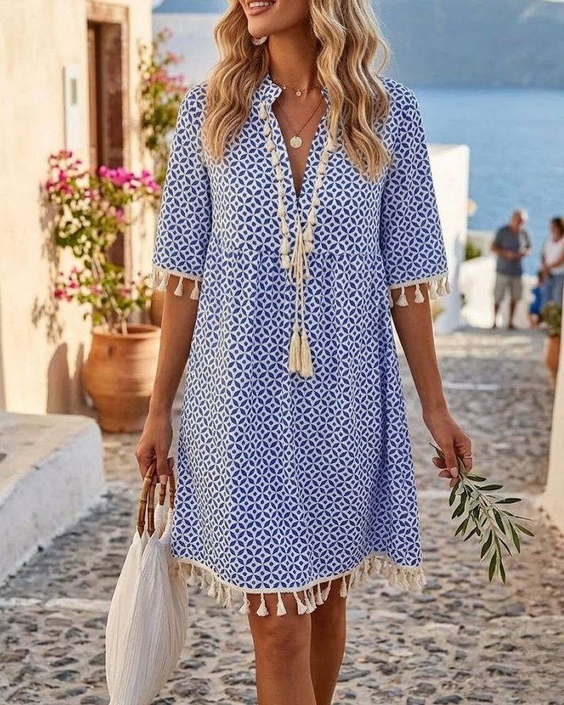 Women's blue boho mini tunic dress with geometric print and playful tassel fringe, perfect for summer.