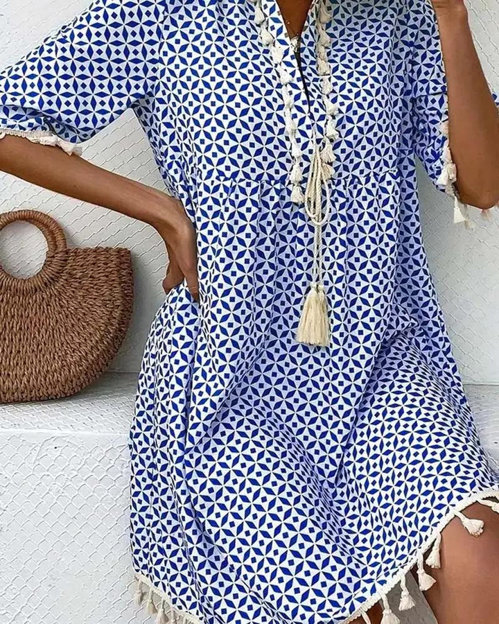 Stylish women's blue geometric print boho tunic dress with delicate tassel fringe, a comfy spring fashion choice.