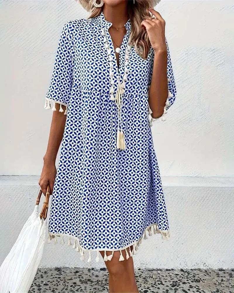 Lightweight blue geometric print mini dress with boho style and tassel accents, a must-have vacation outfit.